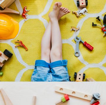 kids in playroom with toys scattered on floor