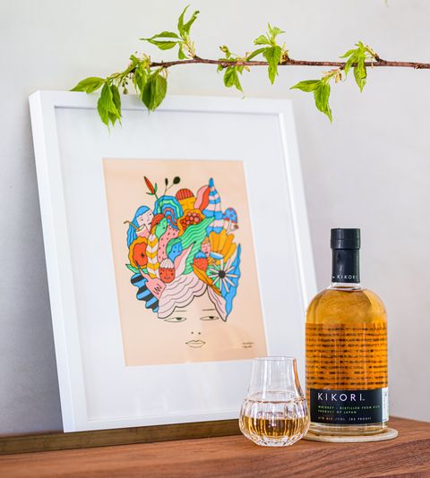 bottle of kikori whiskey with framed art by illustrator carolyn suzuki