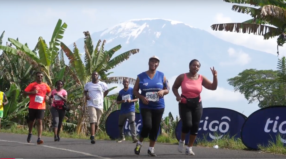 participants running in a race with a backdrop of a mountain