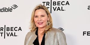 kim cattrall wearing a black blouse and metallic blazer, smiling on the red carpet at the 2023 tribeca festival