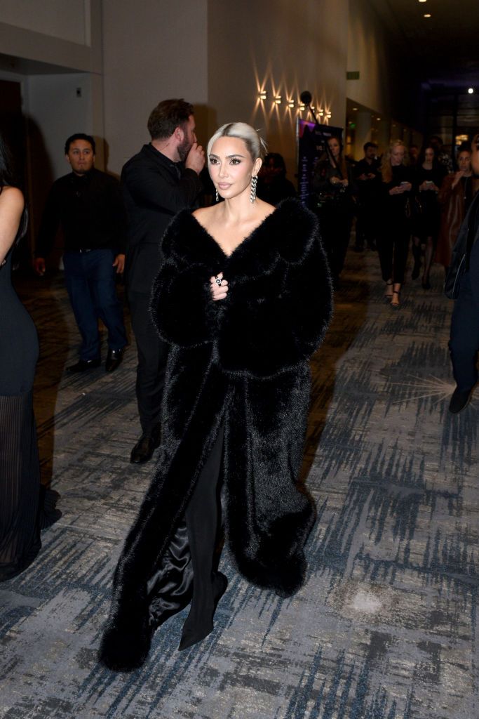 kim kardashian wearing an oversized fur and silver drop earrings