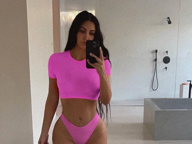 Kim Kardashian stuns in matching neon pink crop top and pants