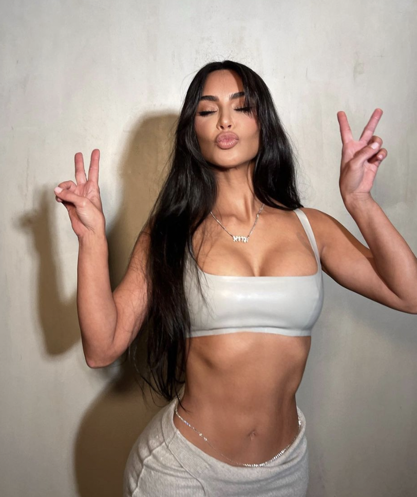 Kim Kardashian showcases her cleavage and svelte abs as she models