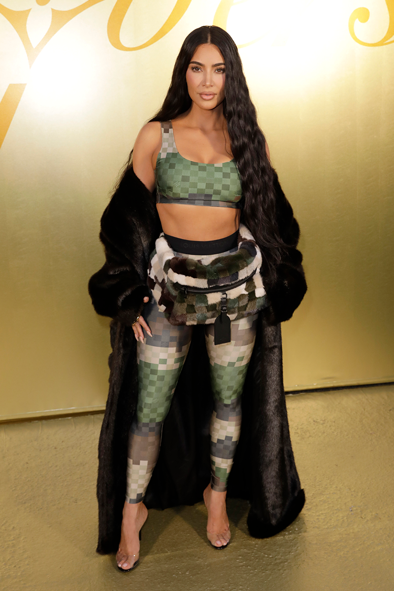 kim kardashian wears a crop top, leggings, and bum bag to the louis vuitton pfw menswear show