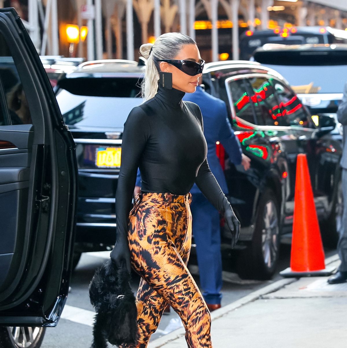 Kim Kardashian Just Wore a Swimsuit Over Her Signature Pant Boots