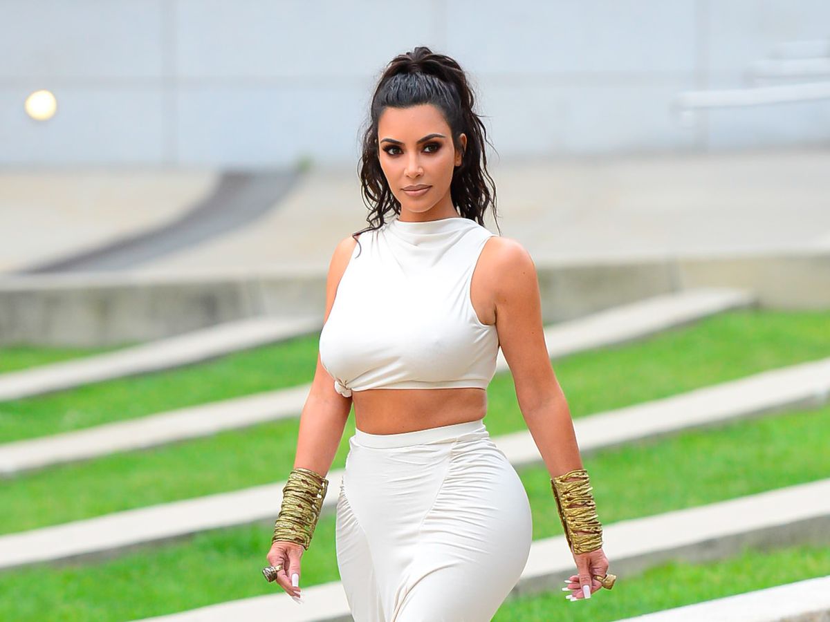 Kim Kardashian shows off her teeny waist in a black bodysuit and