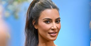 kim kardashian smiles with a ponytail in sports wear