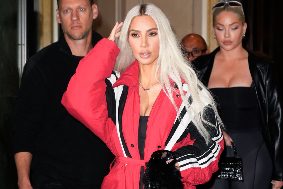 kim kardashian fixing her hair with her right hand as she walks through new york city