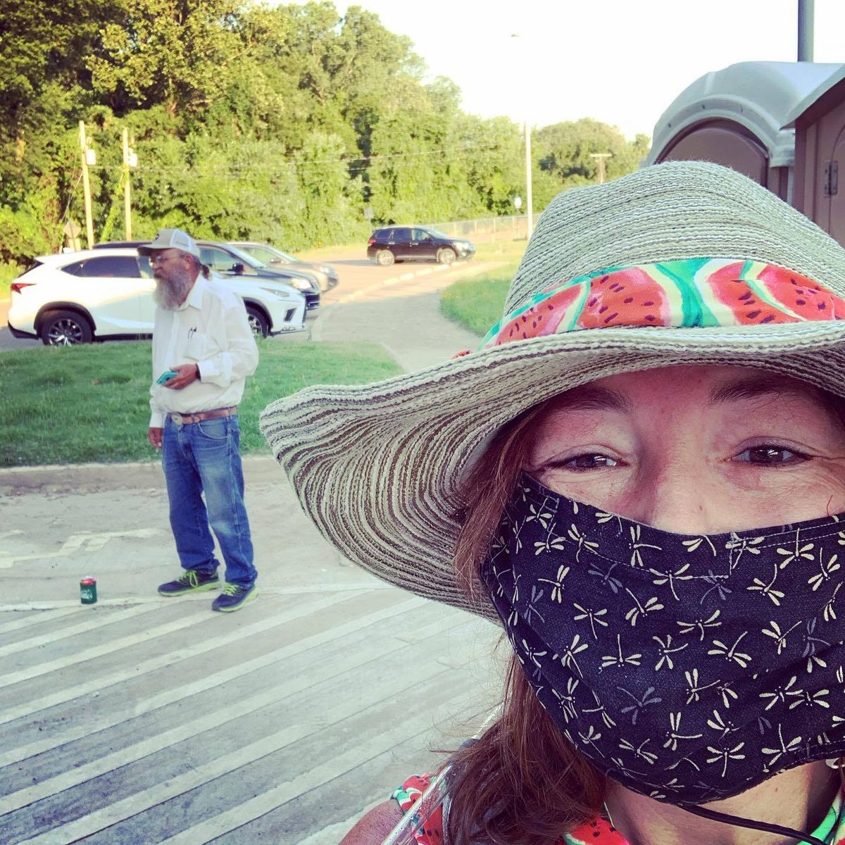 kim mccoy wearing her straw, watermelon themed hat that she made for herself for the race pictured in the background is gary “lazarus lake” cantrell
