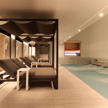 a room with a pool and a bench