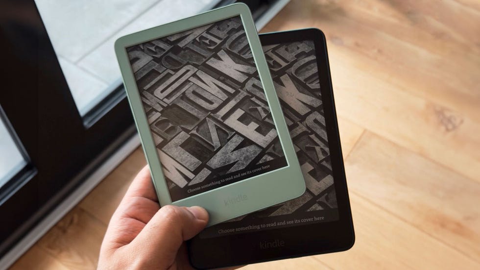 two kindle ereaders held by a hand displaying different book cover screens