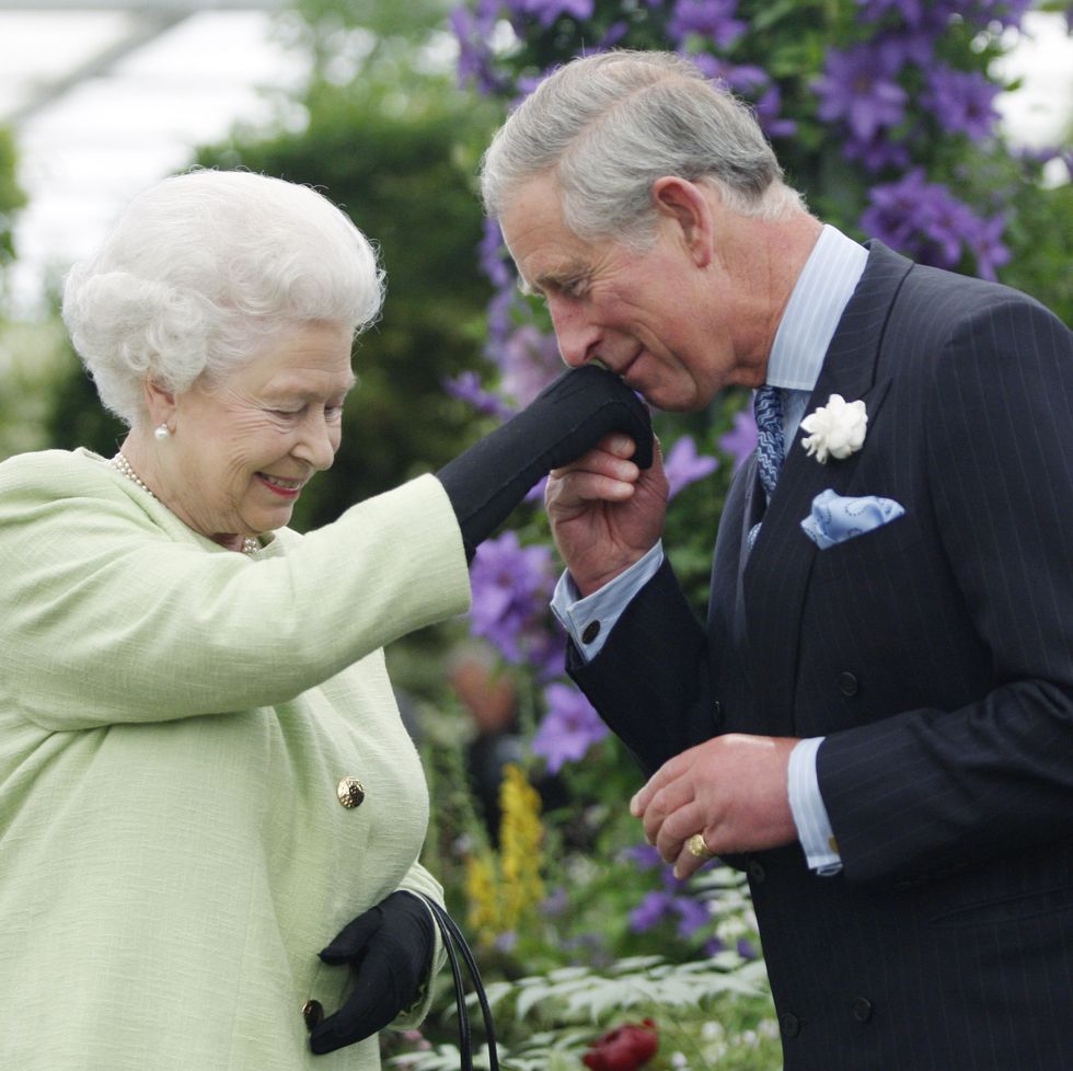 queen elizabeth ii presents prince charles, prince of wales with the royal horticultural societys victoria medal of honour during a visit to the chelsea flower show on may 18, 2009