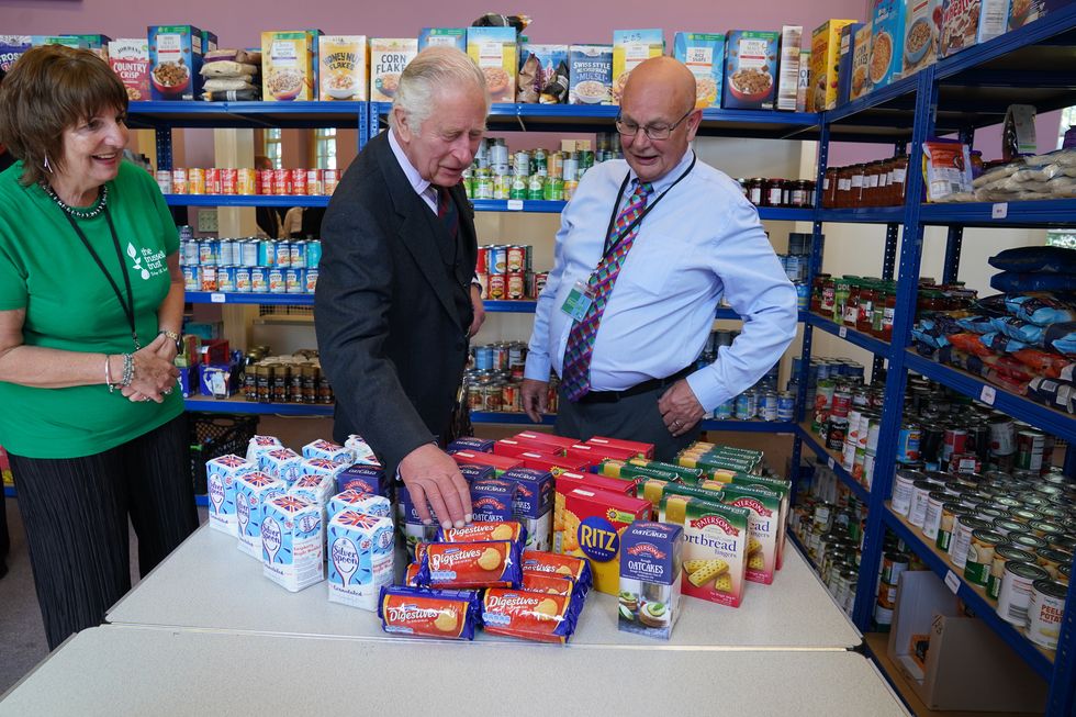 wick, scotland july 29 prince charles, prince of wales, views food he has donated with pat and grant ramsay as he meets volunteers and supporters of caithness food bank at carnegie library on july 29, 2022 in wick, scotland photo by andrew milligan wpa poolgetty images