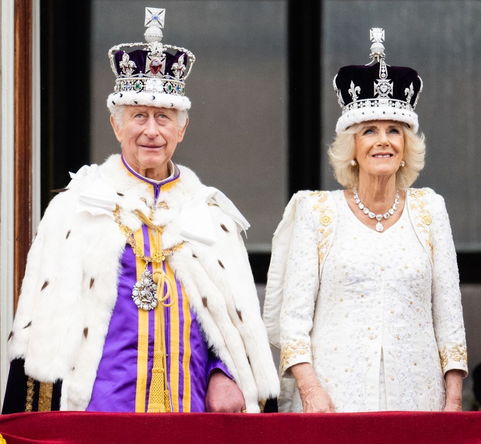 a man and woman wearing crown and gowns