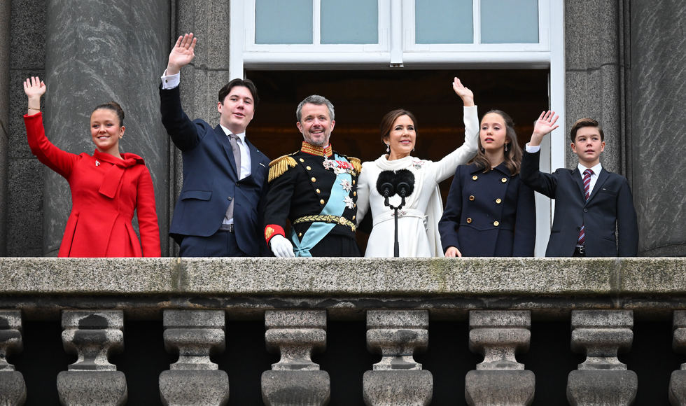 King Frederick waves with his wife Mary and their four children on the balcony