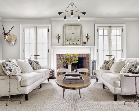 All-white living room with brick fireplace