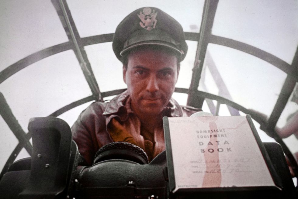 alan arkin wearing a navy hat and uniform in a submarine