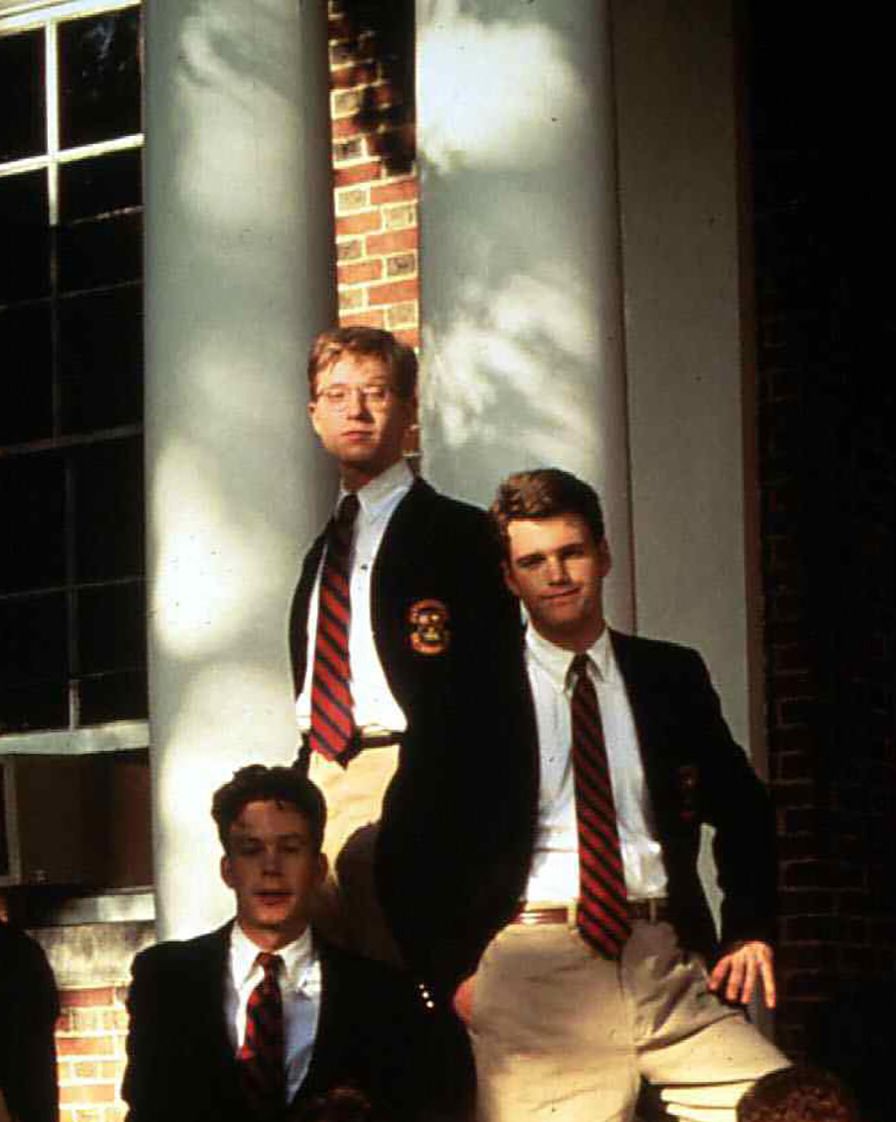 a publicity photo from the movie school ties featuring several male characters in blazers and ties sitting on the steps of a prep school, matt damon and ben affleck are two of the characters