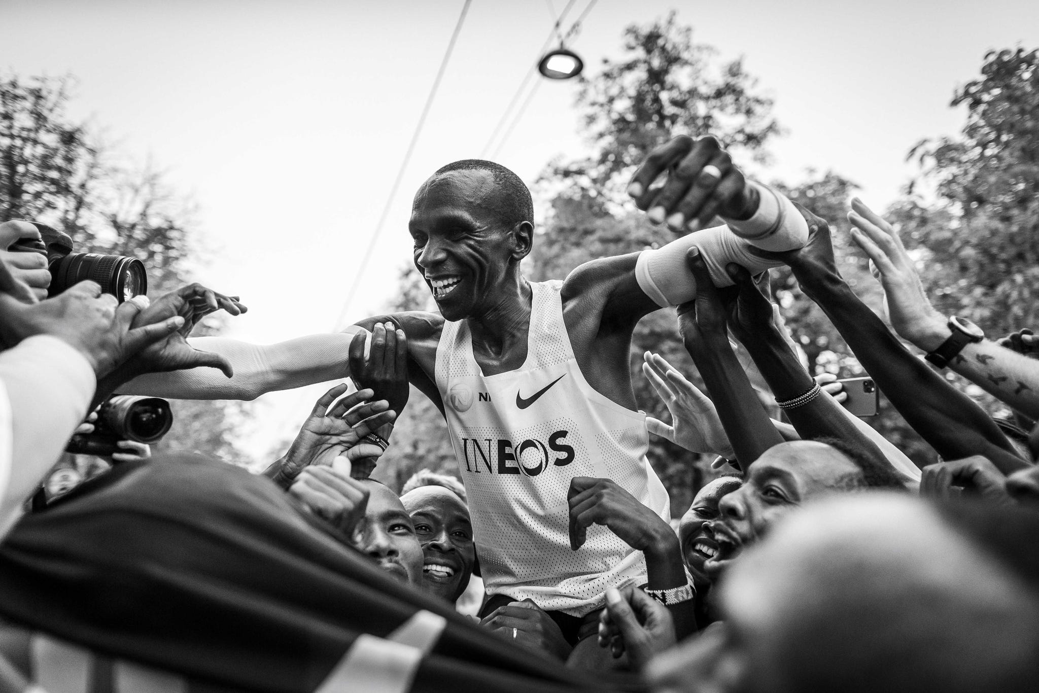 kipchoge in ineos tank on shoulders of pacers