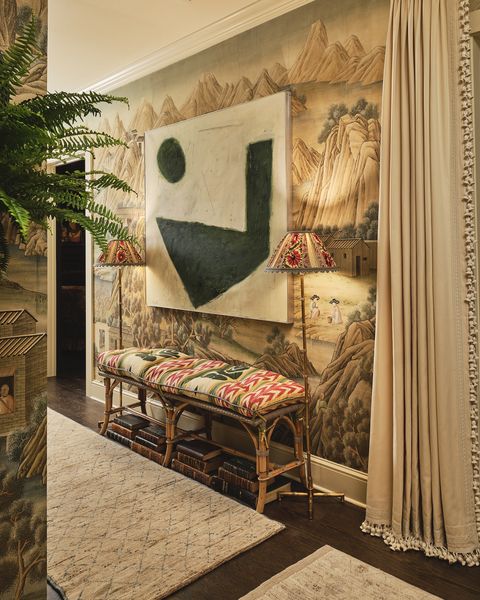 kips bay dallas 2021 caroline gidiere basement hallway with scenic wallpaper rattan bench books modern art