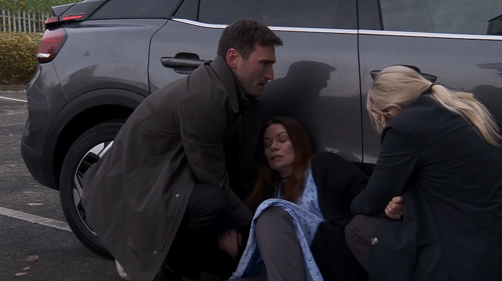 coronation street, lisa swain and kit green helping to carry carla connor