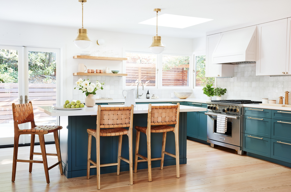 kitchen with blue green cabinets and white walls