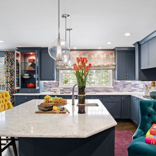large kitchen with blue cabinets and colorful accents 