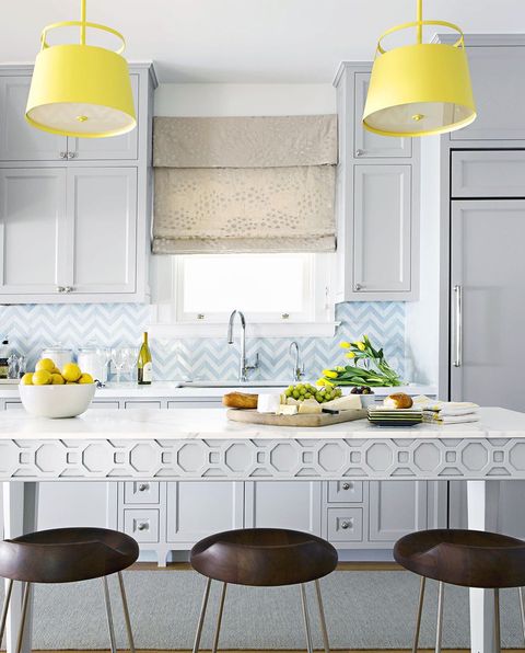 kitchen backsplash ideas, chevron pattern in the kitchen with white cabinets and yellow lighting