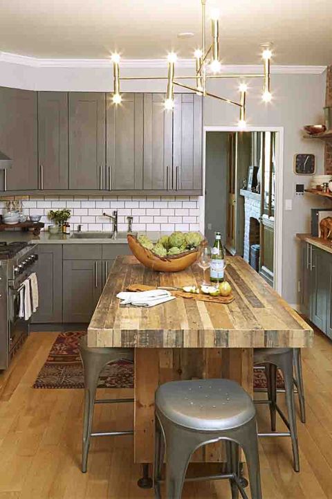 kitchen backsplash ideas, white subway tile in the kitchen with a wood table and bar stools