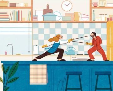 two people engaging in a playful sword fight in a kitchen