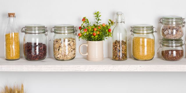 Kitchen bench shelves with various food ingredients on white background