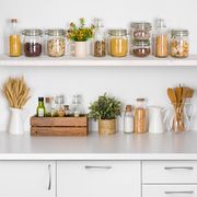 Kitchen bench shelves with various food ingredients on white background
