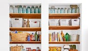 wood cabinet shelves with baskets and jars and kitchen items arranged neatly