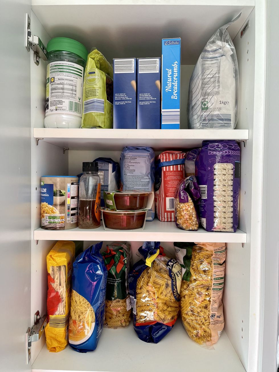 kitchen cabinet stocked with dry food