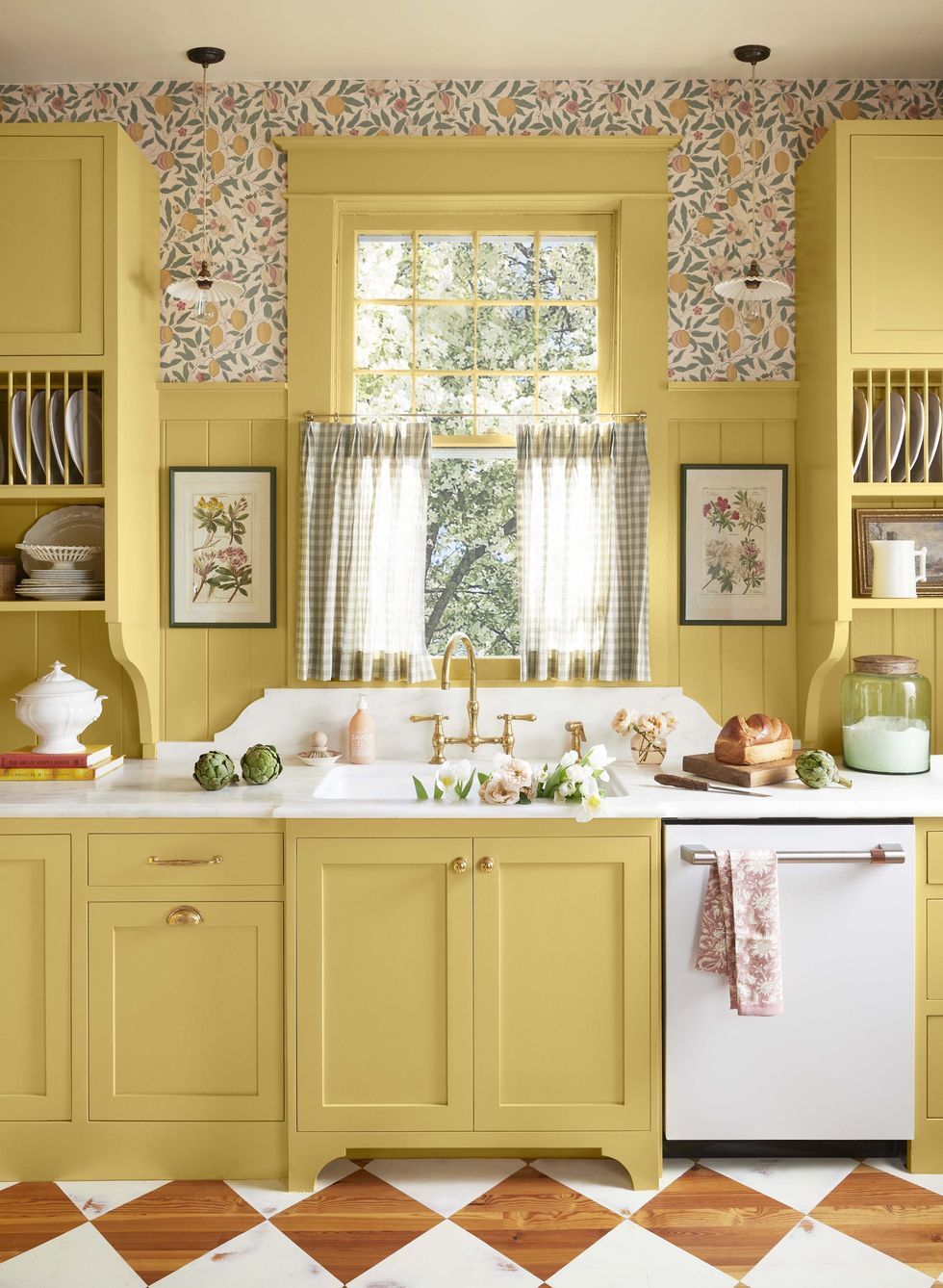 yellow kitchen cabinets with pedestal feet and hutch like upper cabinets with built in plate racks with brass hardware