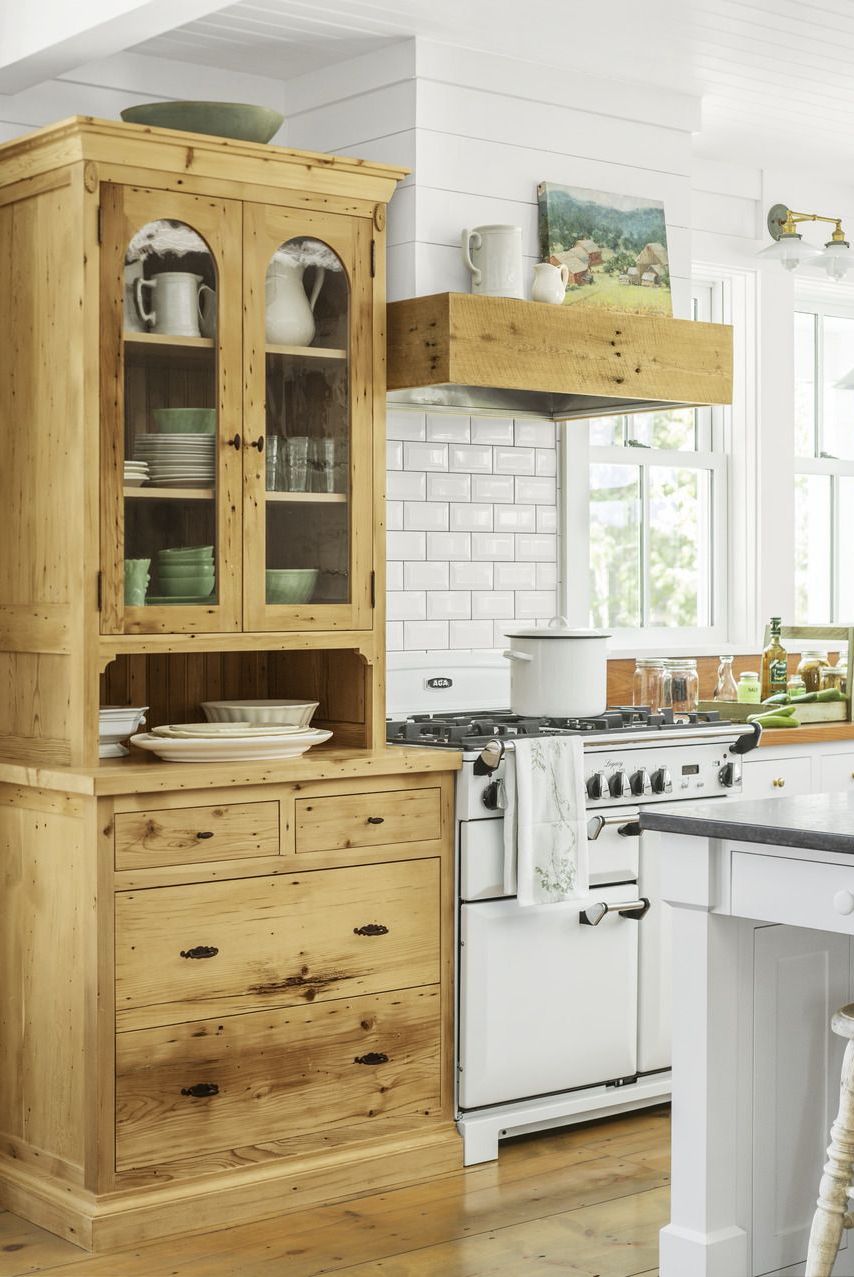warm and welcoming white kitchen showcasing built in natural wood step back cabinet in keeping with the hipstoric trend, homeowner vicki hopper designer cathy chapman