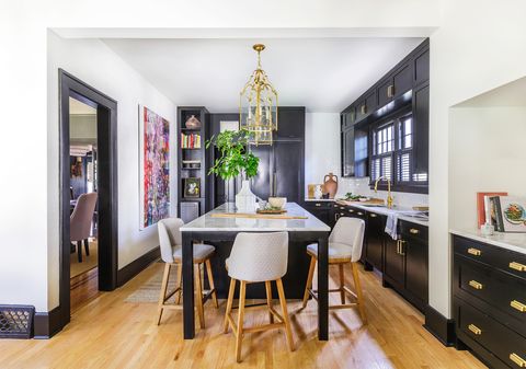 kitchen with black cabinets with gold hardware
