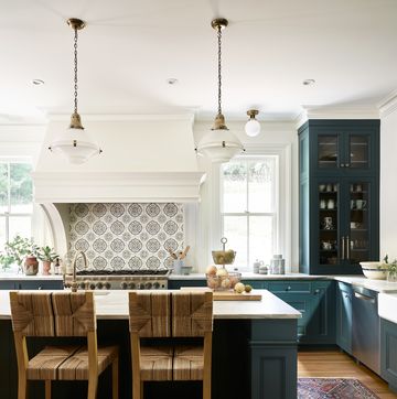 dark marine green kitchen cabinets in british inspired kithcen