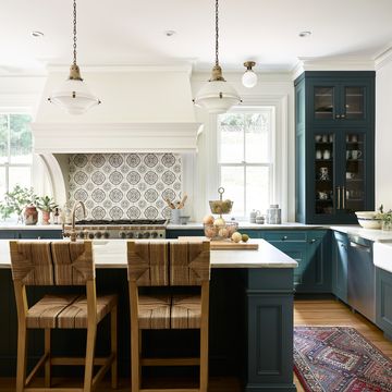 dark marine green kitchen cabinets in british inspired kithcen