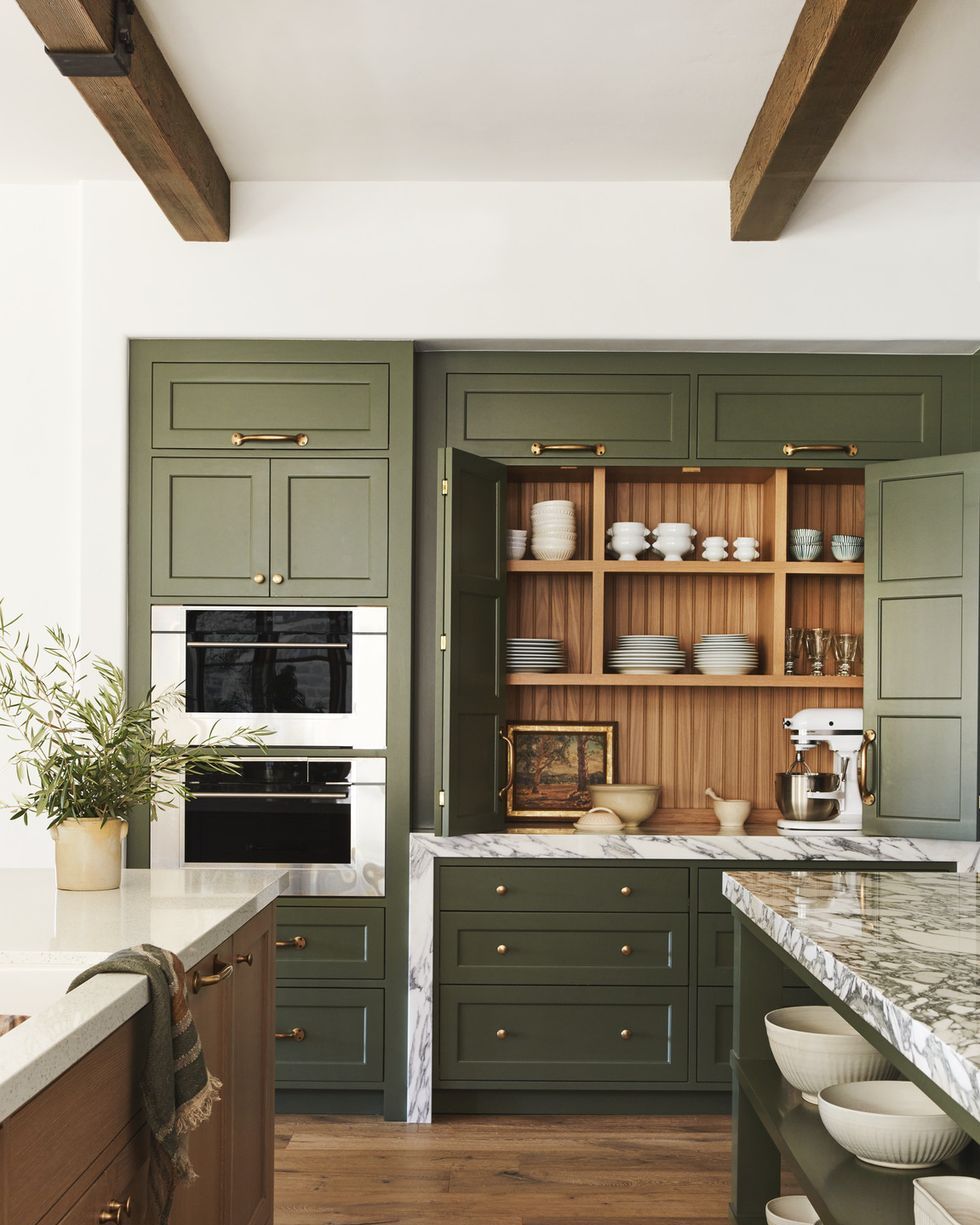 a kitchen with green cabinets