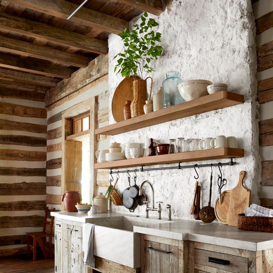 concrete countertops site atop reclaimed wood cabinetry in a mountain house