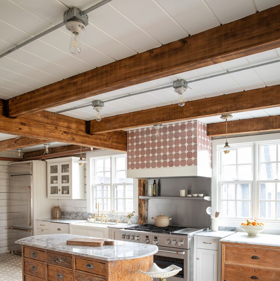 a kitchen that has an old wooden island and a marble top