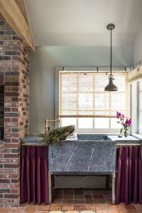 modern english style kitchen with exposed brick and marble sink