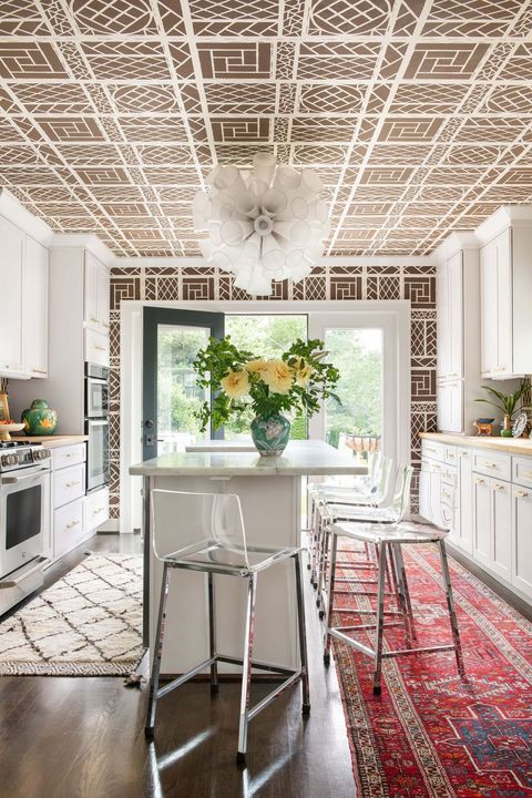 kitchen with patterned wallpaper and rugs