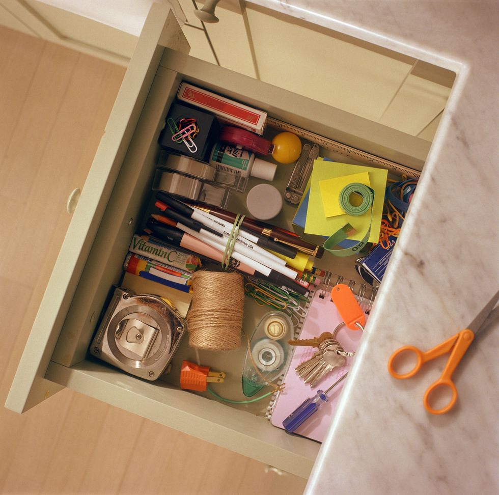 kitchen drawer containing household items, overhead view