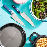 above view shot of kitchen appliances: knives, frying pan, salad bowl and waffle maker with good housekeeping kitchen gear awards logo above view shot of kitchen appliances knives, frying pan, salad bowl and waffle maker with good housekeeping kitchen gear awards logo