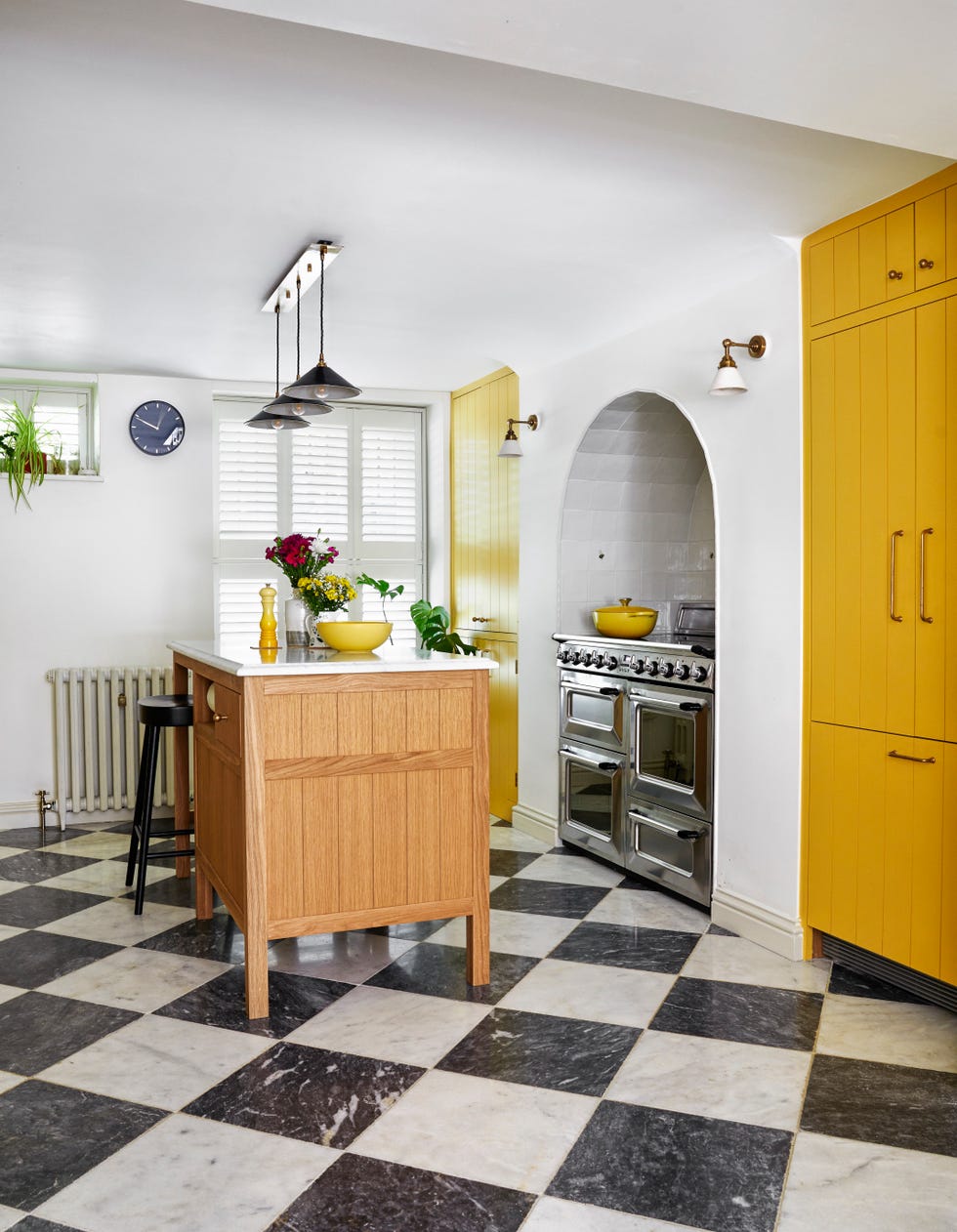 yellow kitchen cabinets and chequerboard floor