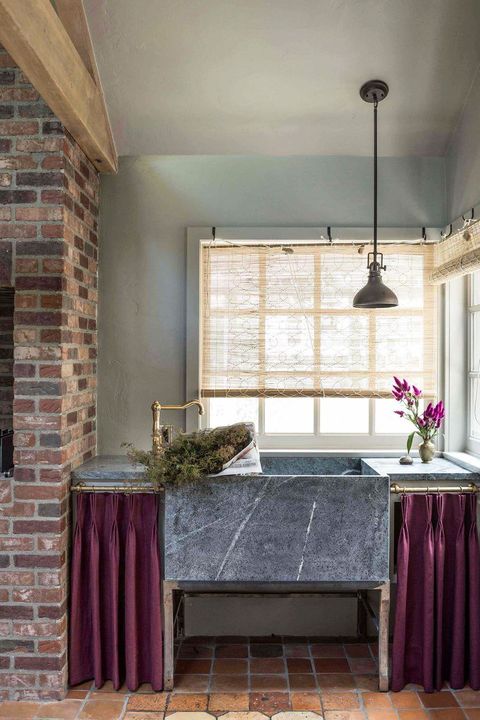 granite kitchen sink with purple curtains on the side