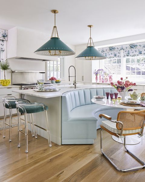 mountain brook, alabama home of hundley hilton’s janie jones designed by birmingham, alabama, duo hundley hilton channel tufted breakfast banquette backs up to a cleverly curved kitchen island banquette leather and mohair stool fabric, kravet range, wolf