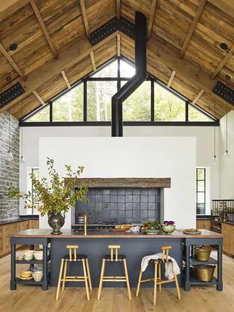 michigan lake house designed by amy meier of california based amy meier design the deep green kitchen island is painted salamander by benjamin moore belgium blue stone tiles, country floors stools, bicyclette